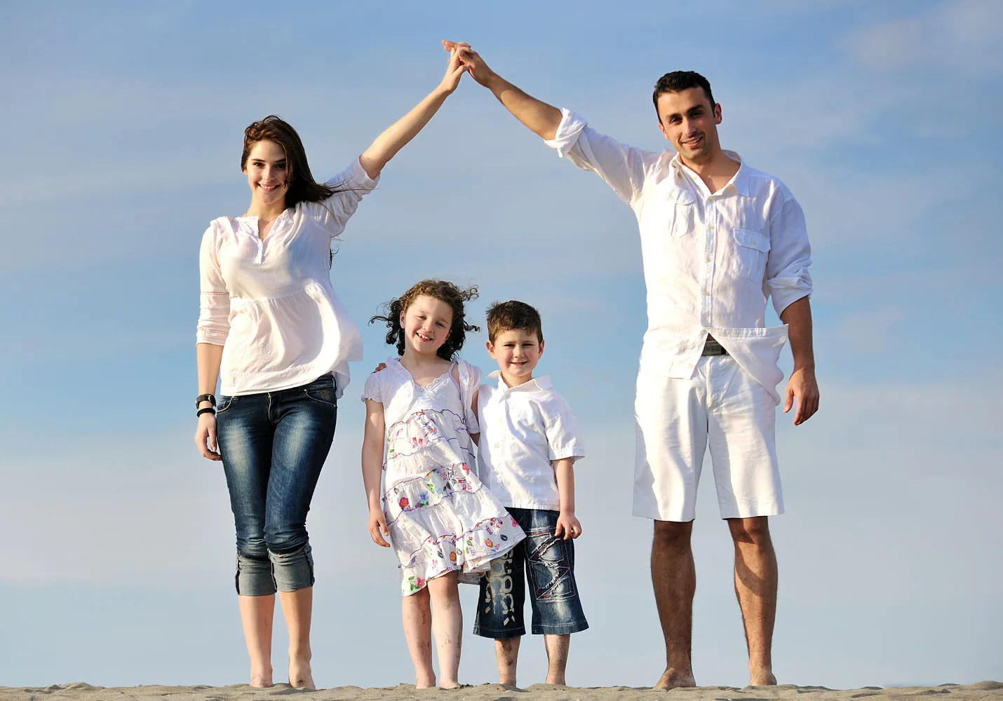 Family on the beach protected by Tidal Shield Insurance